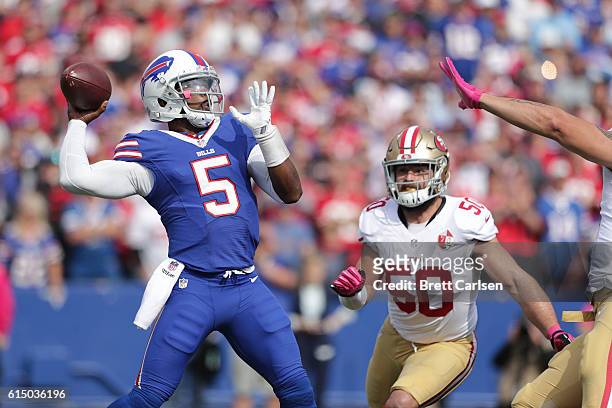 Tyrod Taylor of the Buffalo Bills is pursued by Nick Bellore of the San Francisco 49ers during the first half at New Era Field on October 16, 2016 in...