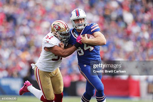 Nick O'Leary of the Buffalo Bills breaks a tackle by Michael Wilhoite of the San Francisco 49ers during the first half at New Era Field on October...