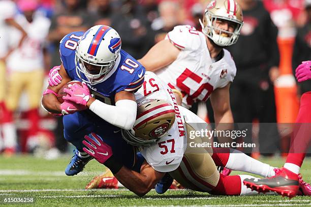 Robert Woods of the Buffalo Bills is brought down by Michael Wilhoite of the San Francisco 49ers during the first half at New Era Field on October...