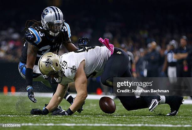 Josh Hill of the New Orleans Saints drops the ball infront of Tre Boston of the Carolina Panthers during the first half of a game at the...