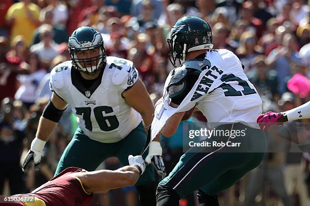 The jersey of quarterback Carson Wentz of the Philadelphia Eagles is torn by outside linebacker Ryan Kerrigan of the Washington Redskins in the first...