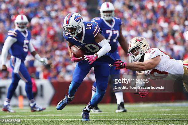 Robert Woods of the Buffalo Bills is grabbed by Nick Bellore of the San Francisco 49ers during the first half at New Era Field on October 16, 2016 in...