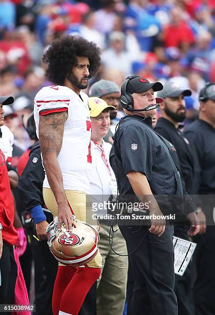 Colin Kaepernick of the San Francisco 49ers and head coach Chip Kelly of the San Francisco 49ers look on from the sideline during the first half...