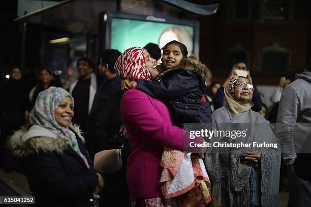 People wrap up warm to watch the switching on of the lights to mark the start of the Hindu festival of Diwali on October 16, 2016 in Leicester,...