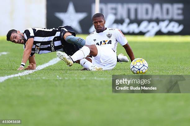 Rodrigo Pimpao of Botafogo struggles for the ball with Carlos Cezar of Atletico Mineiro during a match between Botafogo and Atletico Mineiro as part...