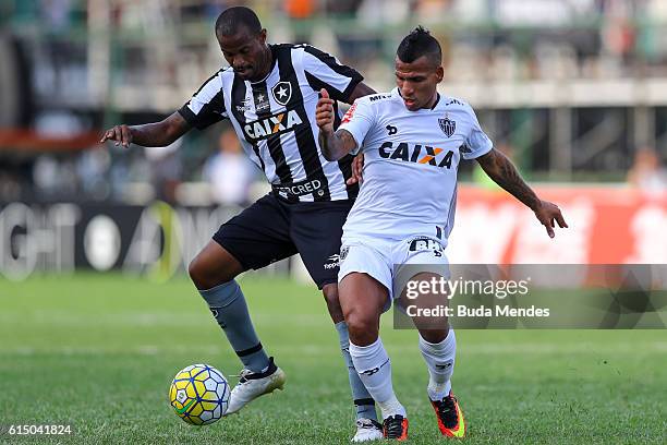Airton of Botafogo struggles for the ball with Romulo Otero of Atletico Mineiro during a match between Botafogo and Atletico Mineiro as part of...