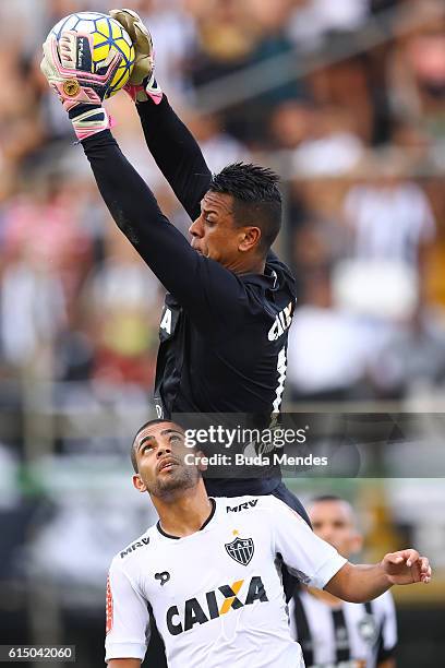 Goalkeeper Sidao of Botafogo struggles for the ball with Clayton of Atletico Mineiro during a match between Botafogo and Atletico Mineiro as part of...