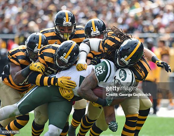 Running back Matt Forte of the New York Jets is tackled by linebackers Vince Williams, Anthony Chickillo and Jarvis Jones and safeties Mike Mitchell...