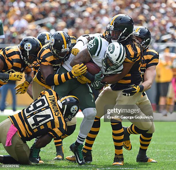 Running back Matt Forte of the New York Jets is tackled by linebackers Lawrence Timmons, Vince Williams, Anthony Chickillo and Jarvis Jones and...