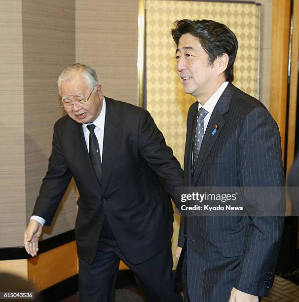 Japan - Hiromasa Yonekura , chairman of the Japan Business Federation, known as Keidanren, greets Shinzo Abe, leader of the main opposition Liberal...