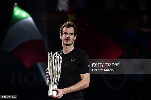 Andy Murray of Great Britain celebrates with his trophy during the award ceremony after winning the Men's singles final match against Roberto...