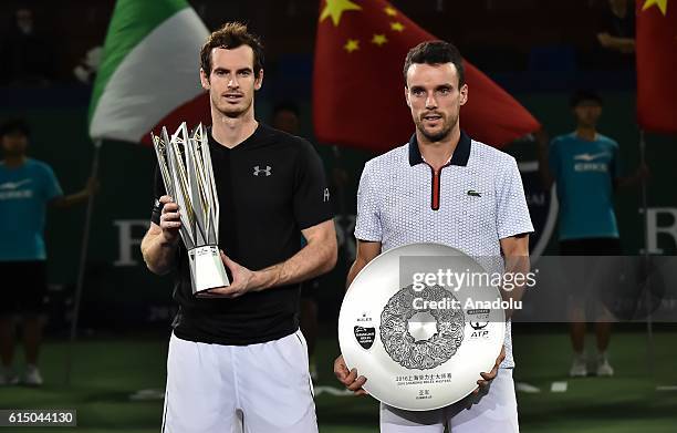 Andy Murray of Great Britain and Roberto Bautista Agut of Spain poses with their trophy after the Men's Single Final Match on day eight of Shanghai...