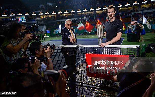 Andy Murray of Great Britain poses with his trophy after the Men's Single Final Match on day eight of Shanghai Rolex Masters at Qi Zhong Tennis...