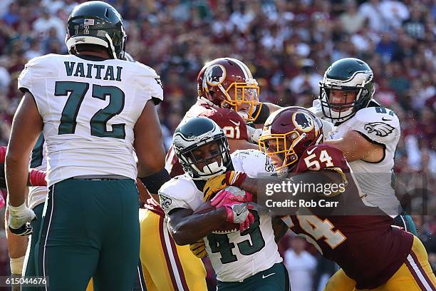 Running back Darren Sproles of the Philadelphia Eagles is tackled by inside linebacker Mason Foster of the Washington Redskins in the fourth quarter...