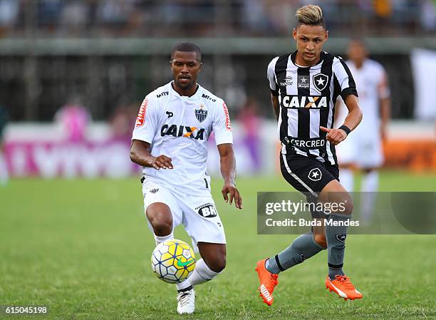 Neilton of Botafogo struggles for the ball with Carlos Cesar of Atletico Mineiro during a match between Botafogo and Atletico Mineiro as part of...