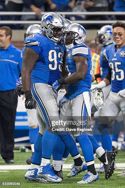 Strong safety Rafael Bush of the Detroit Lions celebrates with defensive tackle Tyrunn Walker after intercepting a pass during the last minutes of an...