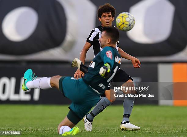 Camilo of Botafogo struggles for the ball with goalkeeper Victor of Atletico Mineiro during a match between Botafogo and Atletico Mineiro as part of...