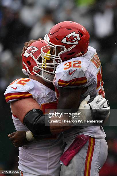 Spencer Ware of the Kansas City Chiefs celebrates with Eric Fisher after a two-yard touchdown against the Oakland Raiders during their NFL game at...