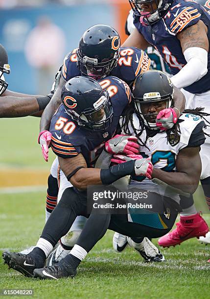 Jerrell Freeman and Harold Jones-Quartey of the Chicago Bears make a tackle against Chris Ivory of the Jacksonville Jaguars in the third quarter of...