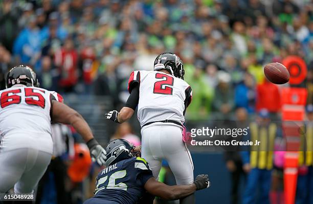 Quarterback Matt Ryan of the Atlanta Falcons fumbles the ball against the defense of defensive end Cliff Avril of the Seattle Seahawks at CenturyLink...