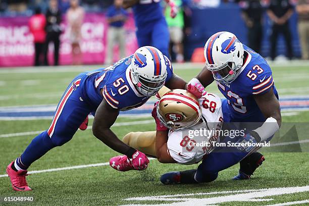 Vance McDonald of the San Francisco 49ers gets hit by Ramon Humber of the Buffalo Bills and Zach Brown of the Buffalo Bills during the second half at...