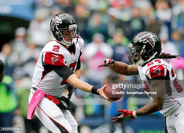 Quarterback Matt Ryan of the Atlanta Falcons hands off to Running back Devonta Freeman against the Seattle Seahawks at CenturyLink Field on October...