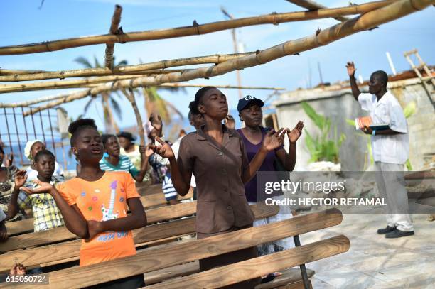 Members of an evangelic church attend church damaged by Hurricane Matthew, in the commune of Roche-a-Bateaux, in Les Cayes, in the southwest of...