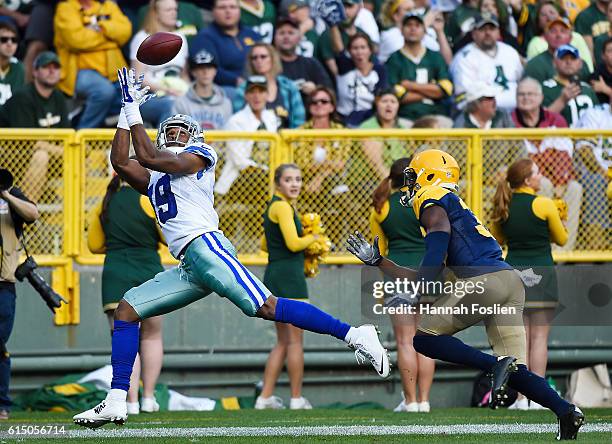 Brice Butler of the Dallas Cowboys catches a touchdown pass under pressure from Micah Hyde of the Green Bay Packers during the second quarter at...
