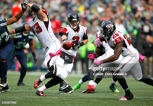 Quarterback Matt Ryan of the Atlanta Falcons hands off to Running back Tevin Coleman against the Seattle Seahawks at CenturyLink Field on October 16,...