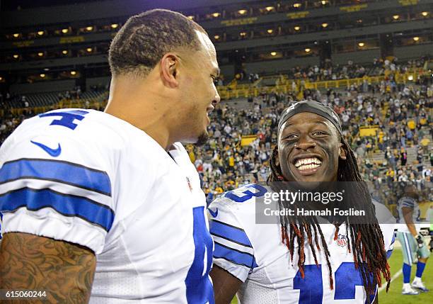 Dak Prescott celebrates with teammate Lucky Whitehead of the Dallas Cowboys after defeating the Green Bay Packers at Lambeau Field on October 16,...