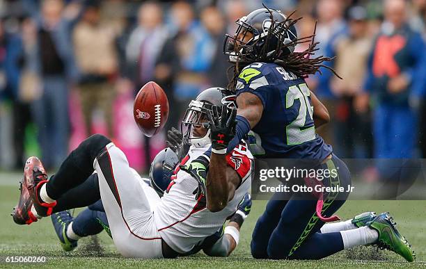 Wide receiver Julio Jones of the Atlanta Falcons can't make the catch on fourth down as cornerback Richard Sherman of the Seattle Seahawks defends at...