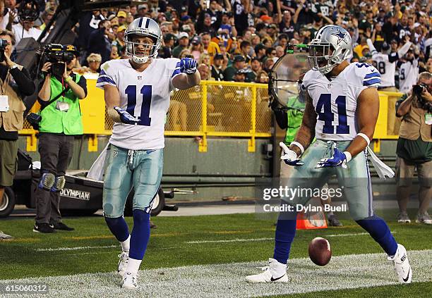 Cole Beasley of the Dallas Cowboys celebrates his touchdown with teammate Keith Smith against the Green Bay Packers during the fourth quarter at...