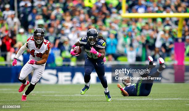 Running back Alex Collins of the Seattle Seahawks takes a pass upfield against the Atlanta Falcons at CenturyLink Field on October 16, 2016 in...