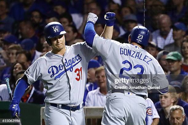 Adrian Gonzalez of the Los Angeles Dodgers celebrates with Joc Pederson after hitting a solo home run in the second inning against the Chicago Cubs...