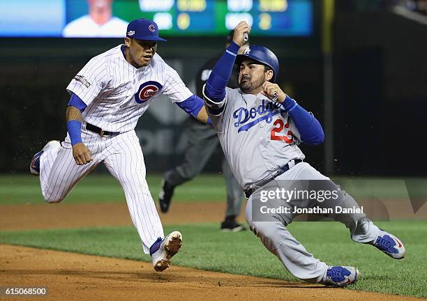 Addison Russell of the Chicago Cubs chases Adrian Gonzalez of the Los Angeles Dodgers in the sixth inning before tagging him out to complete the...