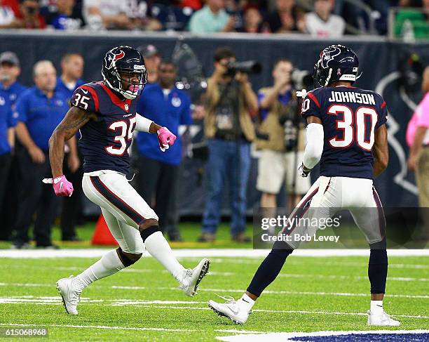 Eddie Pleasant of the Houston Texans and Kevin Johnson celebrate after a defensive stop against the Indianapolis Colts in the first quarter at NRG...