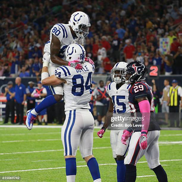 Jack Doyle of the Indianapolis Colts celebrates with Chester Rogers after scoring in the second quarter as Andre Hal of the Houston Texans looks on...