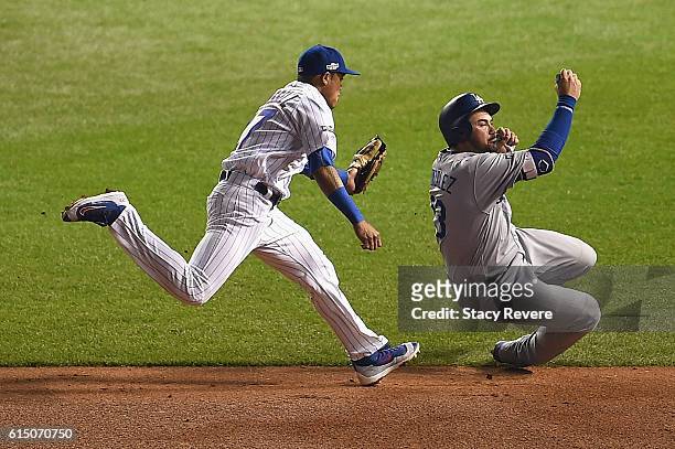 Addison Russell of the Chicago Cubs chases Adrian Gonzalez of the Los Angeles Dodgers in the sixth inning before tagging him out to complete the...