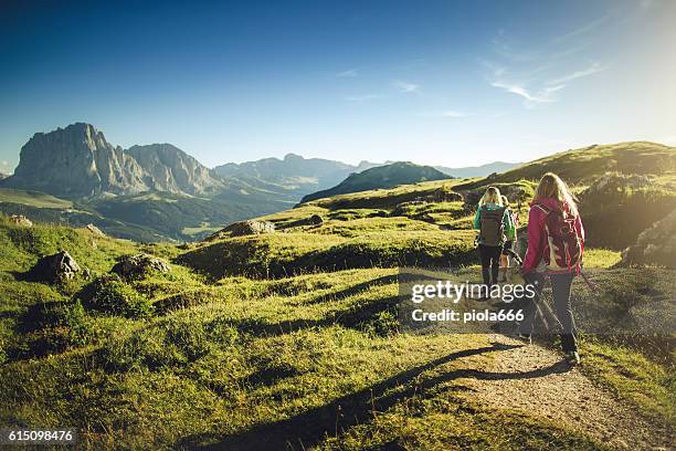 adventures on the mountain: women together - backpacker stock pictures, royalty-free photos & images