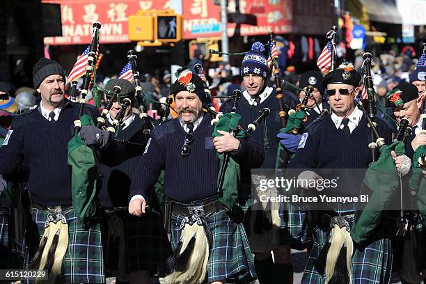 pipe band march in chinese new year parade - street style new york city march 2016 stock pictures, royalty-free photos & images