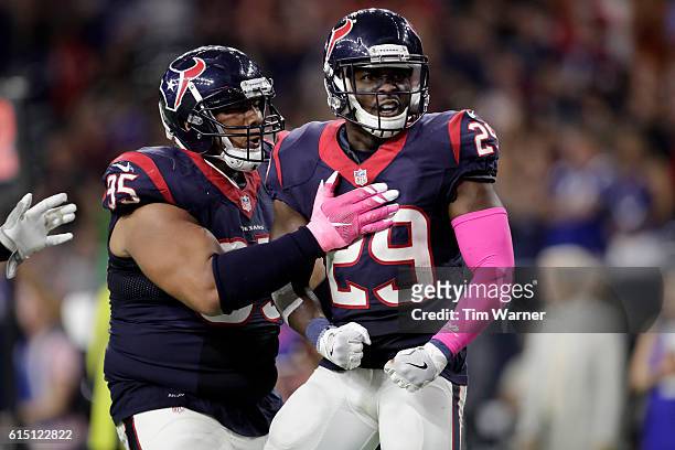 Andre Hal of the Houston Texans celebrates with Christian Covington of the Houston Texans after a sacking Andrew Luck of the Indianapolis Colts in...