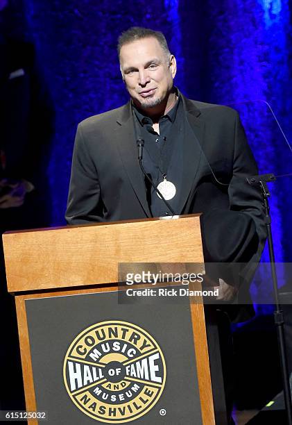 Garth Brooks honors inductee Randy Travis onstage during the 2016 Medallion Ceremony at Country Music Hall of Fame and Museum on October 16, 2016 in...