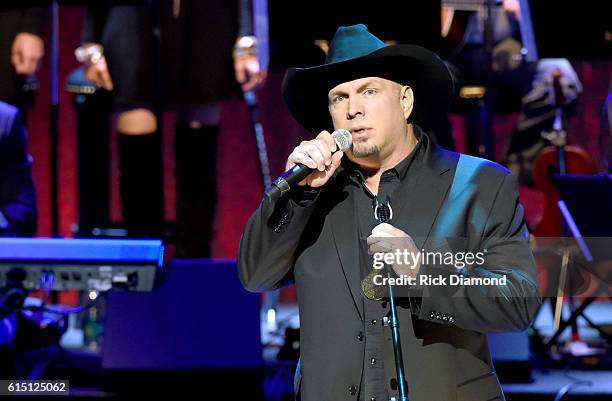 Garth Brooks performs 'Three Wooden Crosses' to honor Randy Travis onstage during the 2016 Medallion Ceremony at Country Music Hall of Fame and...