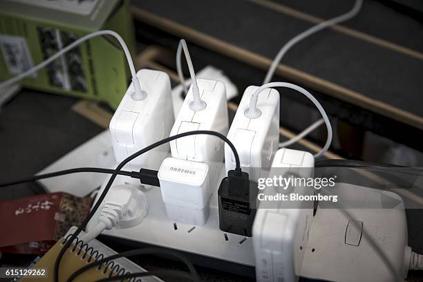 Apple Inc. Computer chargers, Samsung Electronics Co. USB charger and other plugs are attached to an extension power socket at the office of...