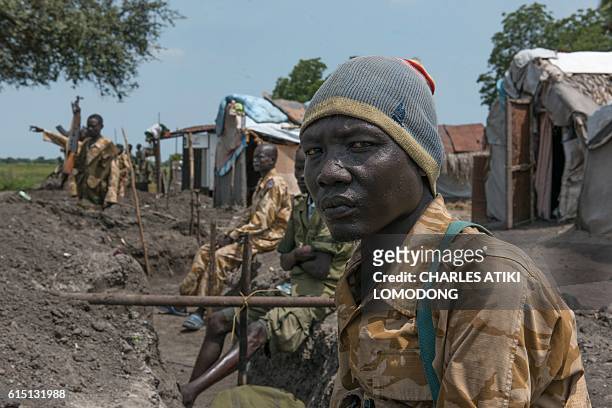 Sudan People Liberation Army soldiers stand in their trenches in Aleleo, Fashoda State, northern South Sudan, on October 16, 2016. Heavy fighting...