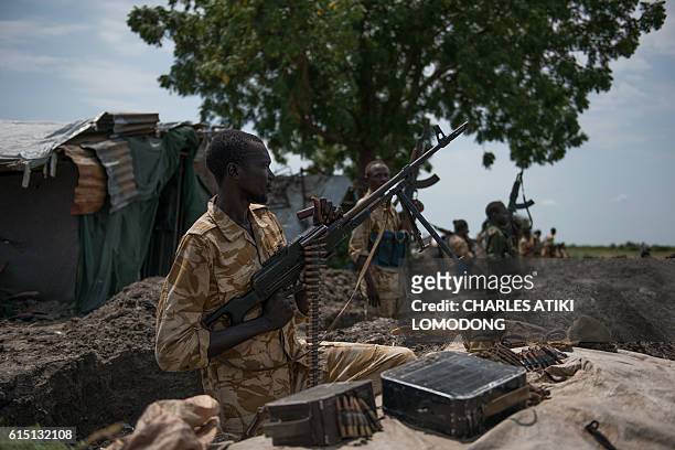 Sudan People Liberation Army soldiers stand in their trenches in Aleleo, Fashoda State, northern South Sudan, on October 16, 2016. Heavy fighting...