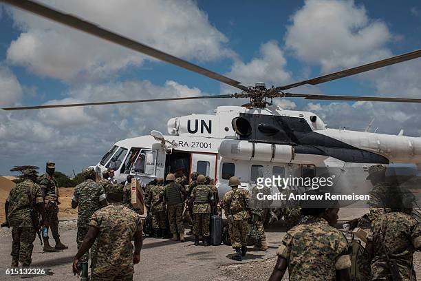 Members of the 17th Battle Group of the Uganda People's Defense Force serving in the African Union Mission in Somalia load an United Nations...