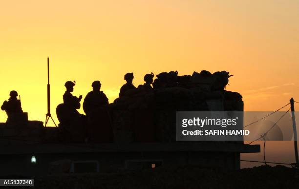Iraqi Kurdish Peshmerga fighters deploy on the top of Mount Zardak, about 25 kilometres east of Mosul, as they take part in an operation against...