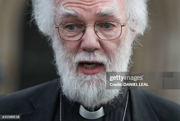 Former Archbishop of Canterbury, Rowan Williams, poses for a photograph after adressing the media, in front of Croydon Minster in Croydon, south...