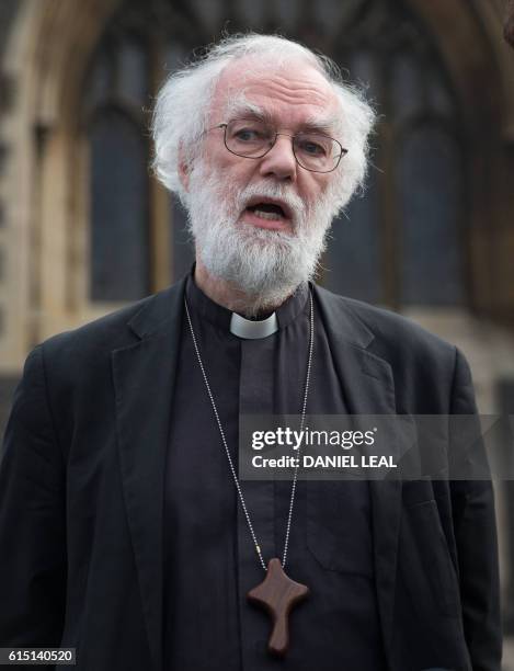 Former Archbishop of Canterbury, Rowan Williams, poses for a photograph after adressing the media, in front of Croydon Minster in Croydon, south...
